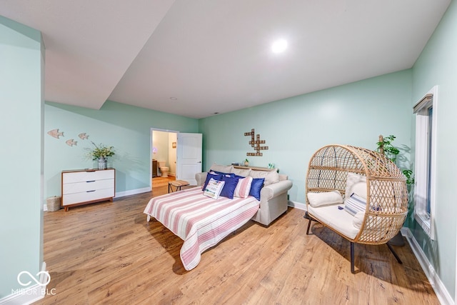 8205 Bass Dr, Nineveh, IN 46164 - bedroom featuring wood finished floors, baseboards, and ensuite bath