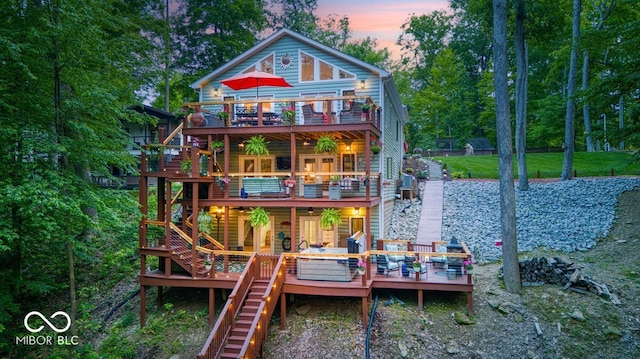 8205 Bass Dr, Nineveh, IN 46164 - back of house at dusk with stairway, a deck, a balcony, and ceiling fan