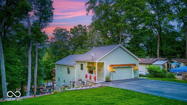 8205 Bass Dr, Nineveh, IN 46164 - view of front facade with an attached garage, a front yard, driveway, and view of wooded area
