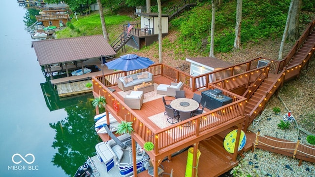 8205 Bass Dr, Nineveh, IN 46164 - dock area featuring stairs, an outdoor living space, boat lift, a deck, and outdoor dining space