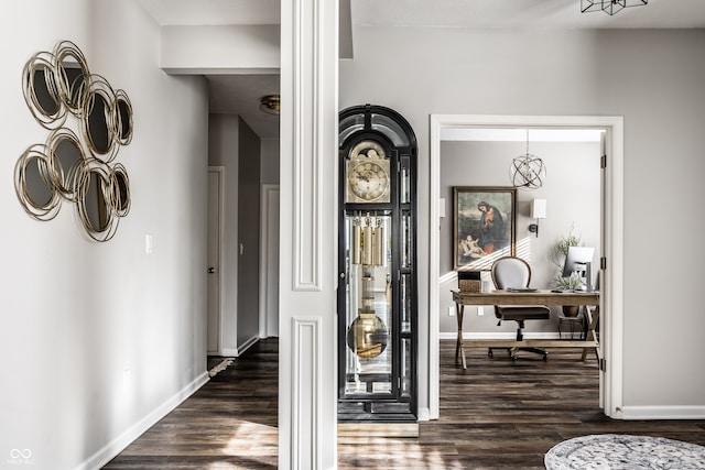 foyer entrance with baseboards and dark wood-style floors