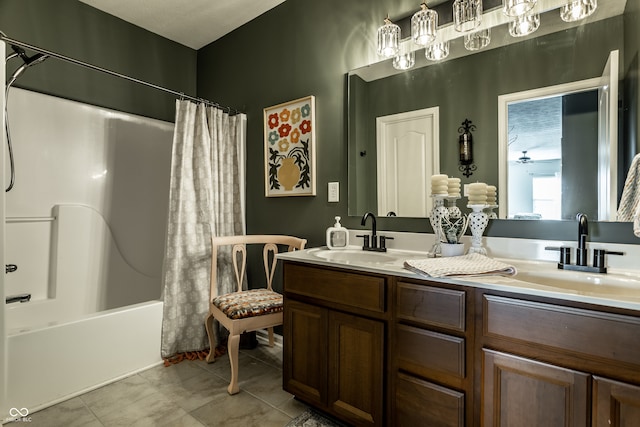 full bathroom with double vanity, shower / bath combination with curtain, tile patterned floors, and a sink