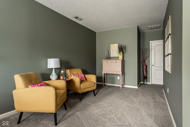 sitting room featuring carpet, visible vents, and baseboards