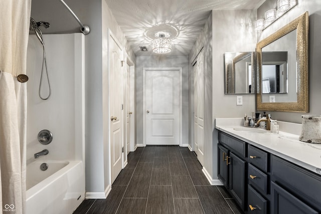 bathroom featuring vanity, shower / tub combo, baseboards, and wood finish floors