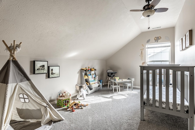 bedroom with visible vents, ceiling fan, vaulted ceiling, carpet floors, and a textured ceiling