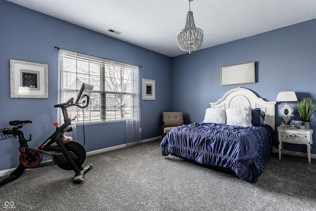 carpeted bedroom featuring a notable chandelier, visible vents, and baseboards