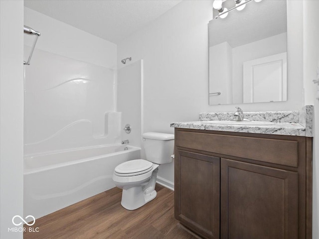 full bathroom with vanity, toilet, wood finished floors, and bathtub / shower combination