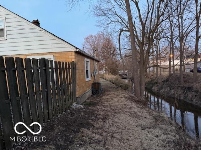 view of home's exterior with fence