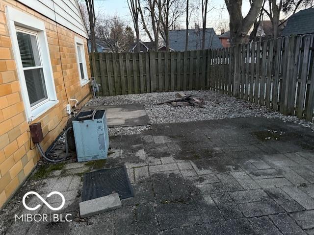 view of patio / terrace with central air condition unit and a fenced backyard