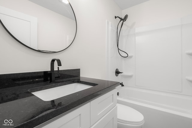 bathroom featuring bathing tub / shower combination, toilet, and vanity