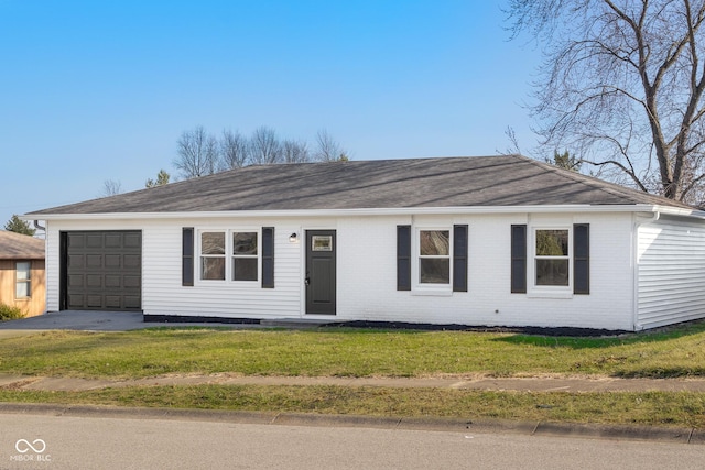 single story home featuring brick siding, a garage, driveway, and a front lawn