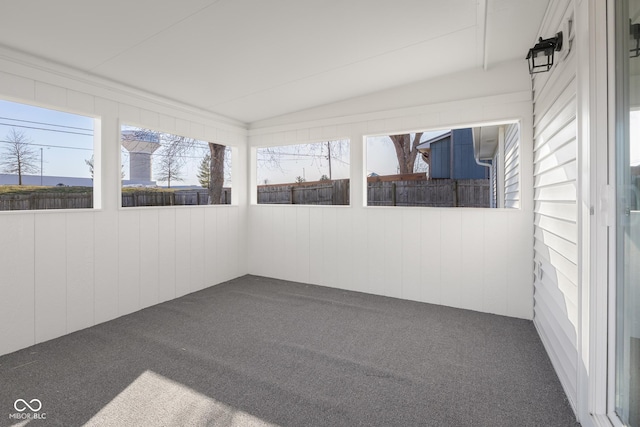 unfurnished sunroom featuring lofted ceiling