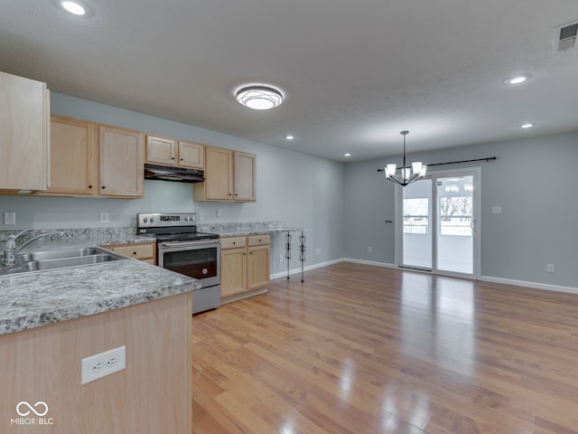 kitchen featuring light brown cabinetry, under cabinet range hood, light countertops, stainless steel range with electric cooktop, and a sink