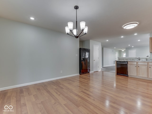 kitchen featuring light wood-style flooring, recessed lighting, black appliances, a notable chandelier, and open floor plan