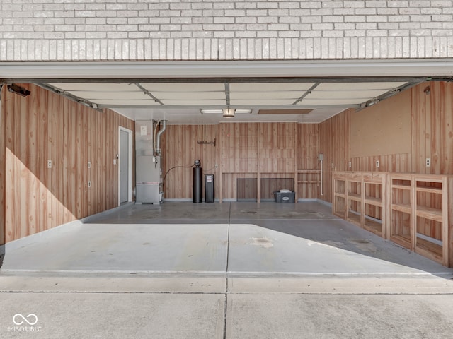 garage with heating unit and wooden walls