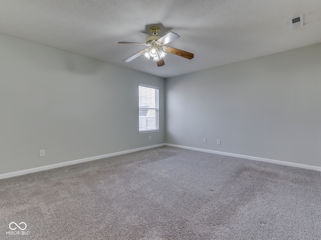 spare room with a ceiling fan, baseboards, and carpet floors