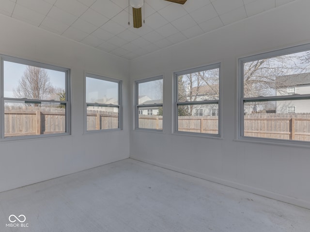 unfurnished sunroom with a ceiling fan