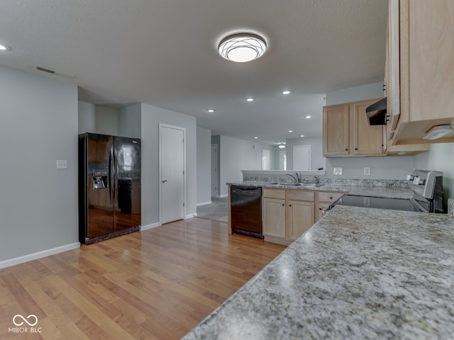 kitchen with range hood, a peninsula, light brown cabinetry, black appliances, and light wood-style floors