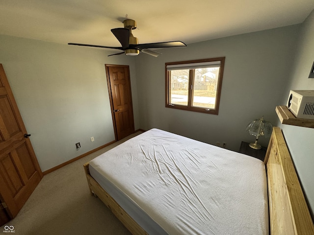 carpeted bedroom with a ceiling fan and baseboards