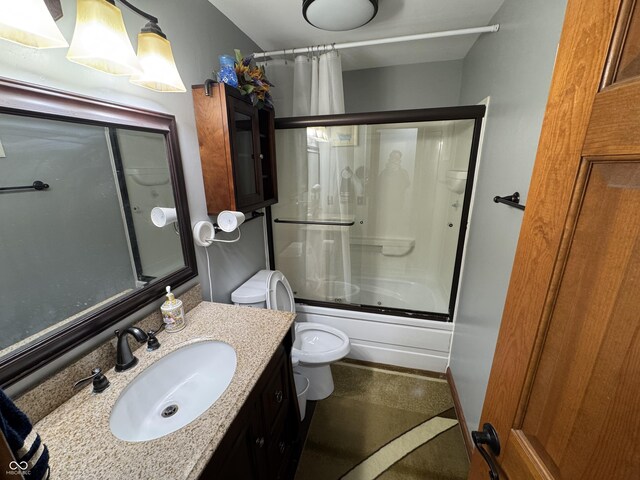 bathroom featuring shower / bath combination with glass door, vanity, and toilet