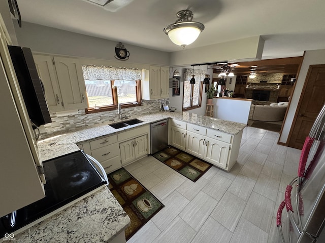 kitchen featuring electric range oven, decorative backsplash, a peninsula, stainless steel dishwasher, and a sink