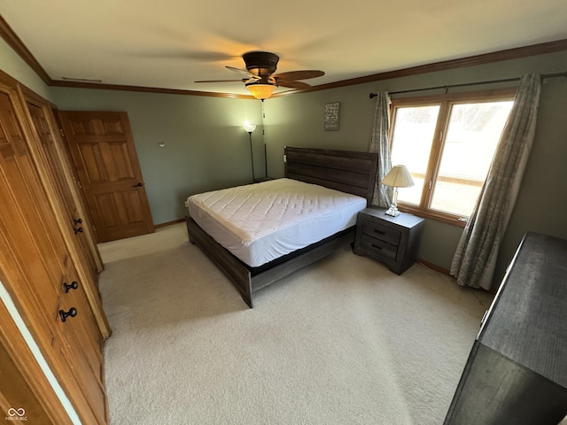 bedroom featuring a ceiling fan, crown molding, light colored carpet, and baseboards