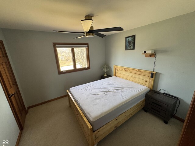 bedroom with baseboards, light colored carpet, and a ceiling fan