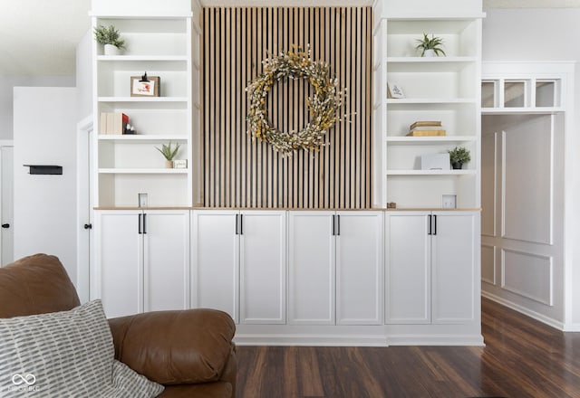 room details featuring built in shelves and wood finished floors