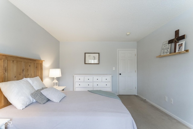 bedroom with a textured ceiling, baseboards, and light carpet