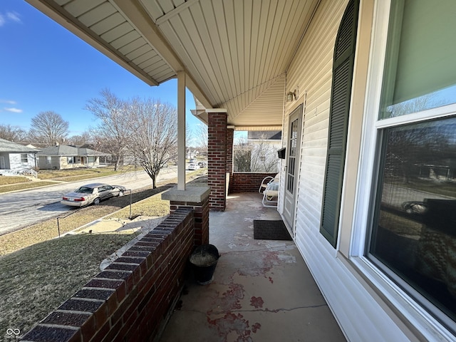 view of patio featuring a residential view and a porch