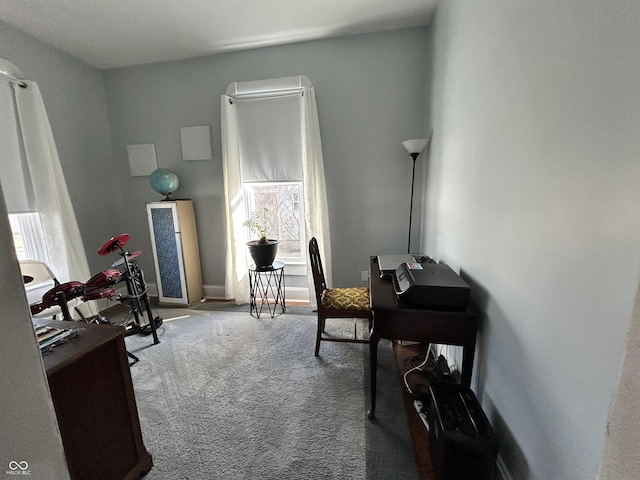 carpeted home office featuring baseboards