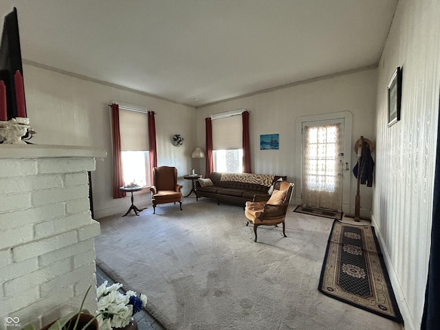 living room with carpet floors, plenty of natural light, a brick fireplace, and ornamental molding