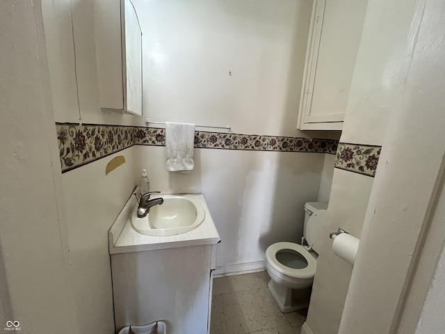 half bathroom with toilet and vanity