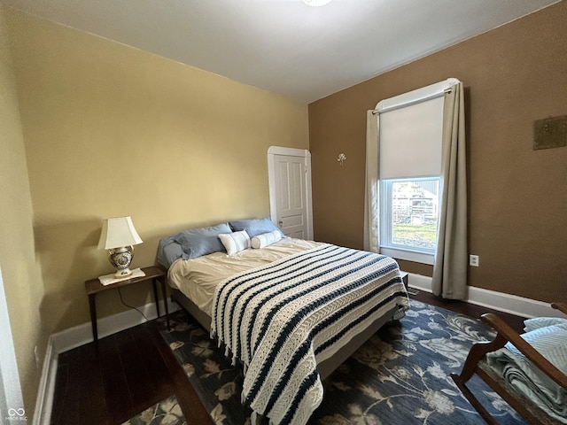 bedroom featuring baseboards and wood finished floors