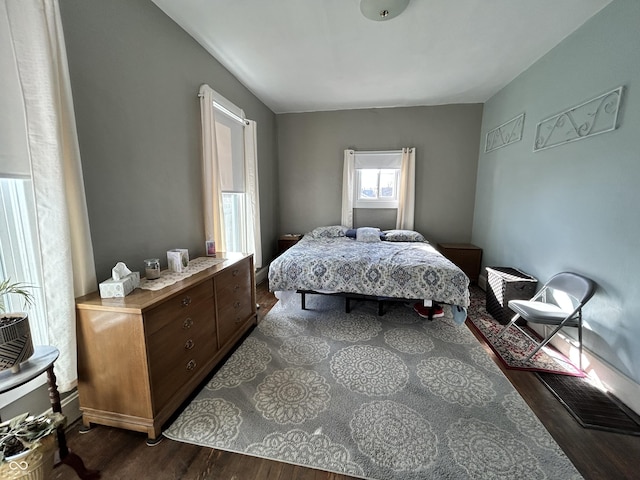 bedroom with dark wood-style flooring