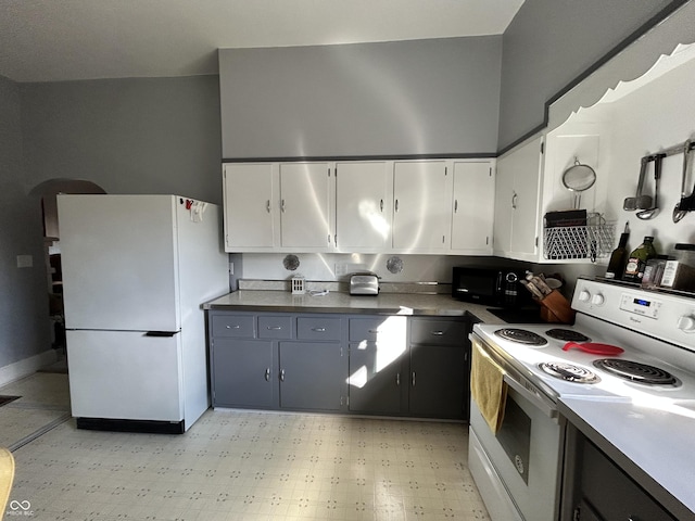 kitchen with white cabinetry, white appliances, and light floors