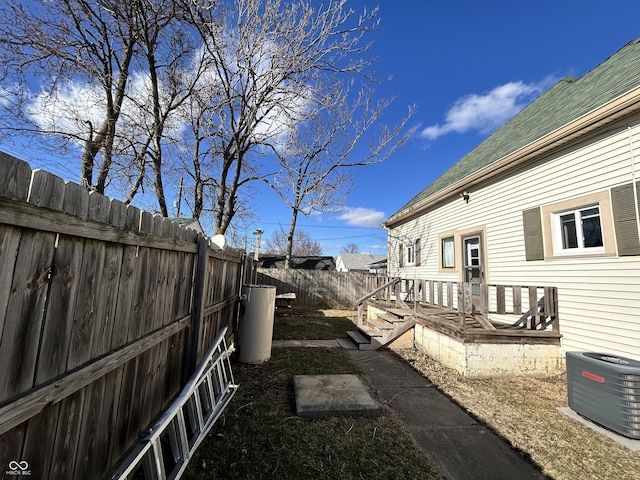 view of yard featuring central air condition unit and a fenced backyard