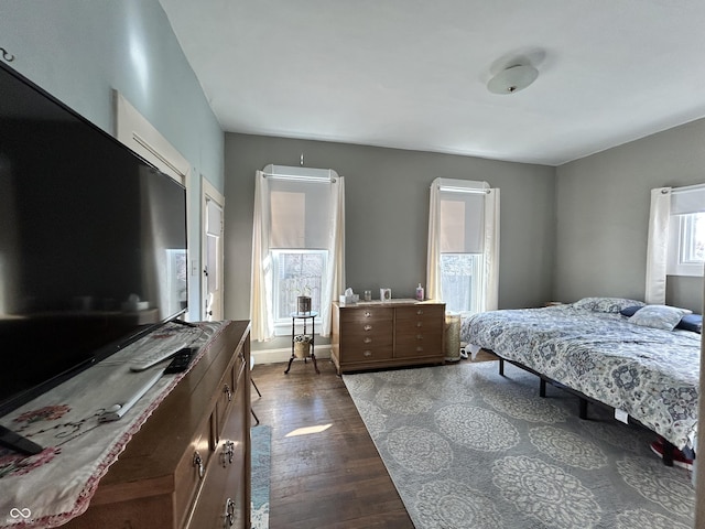 bedroom with dark wood-style floors