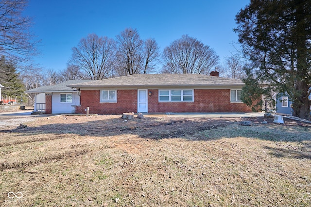 single story home featuring brick siding and a chimney