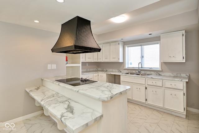 kitchen with premium range hood, a peninsula, a sink, black electric stovetop, and marble finish floor