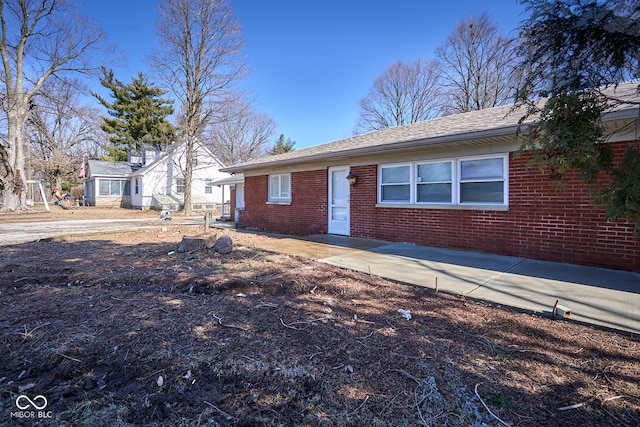 single story home featuring brick siding