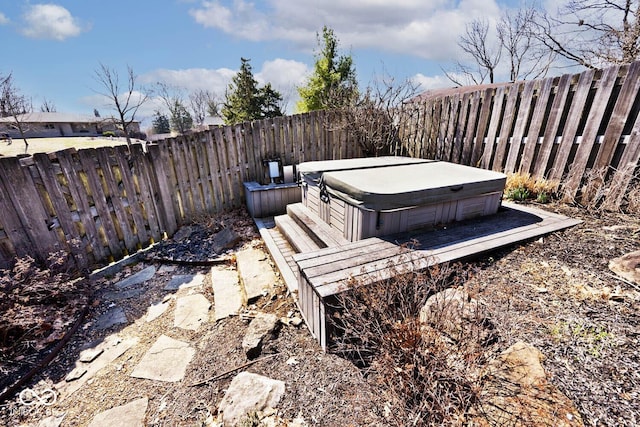 view of yard with a fenced backyard and a hot tub