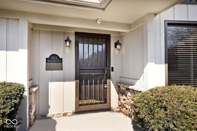 view of exterior entry featuring board and batten siding