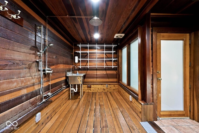 interior space with wooden walls, wood ceiling, and hardwood / wood-style floors