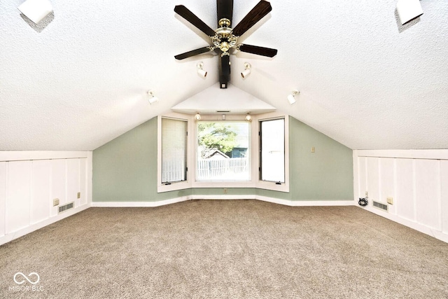 bonus room with visible vents, ceiling fan, vaulted ceiling, carpet floors, and a textured ceiling