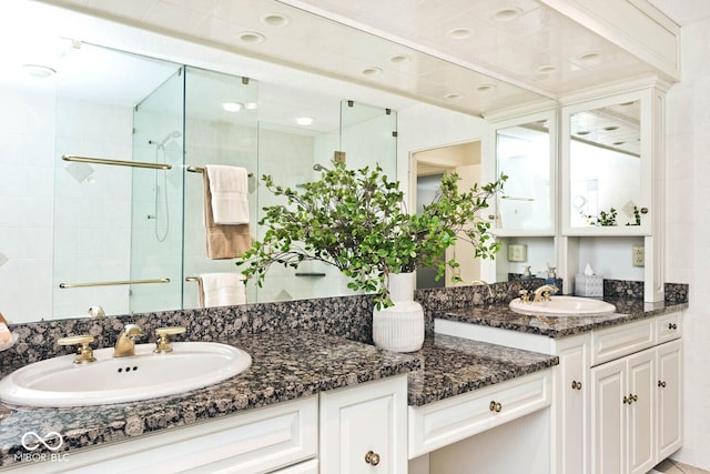 full bathroom with a stall shower and vanity