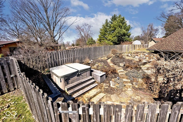 view of yard featuring a fenced backyard and a hot tub