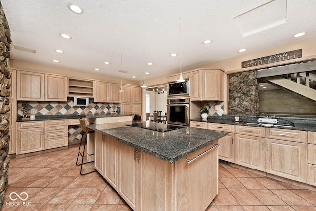 kitchen featuring stainless steel oven, built in microwave, black electric stovetop, and light brown cabinetry