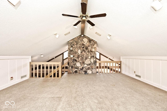 bonus room with vaulted ceiling, carpet flooring, a ceiling fan, and visible vents