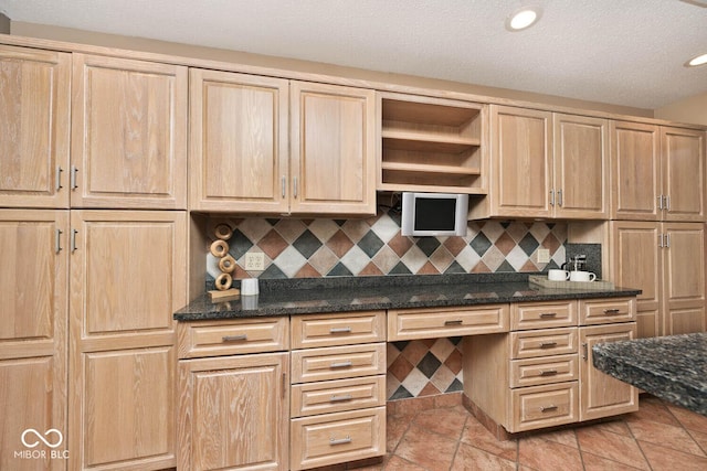 kitchen with light brown cabinetry, light tile patterned floors, backsplash, and recessed lighting